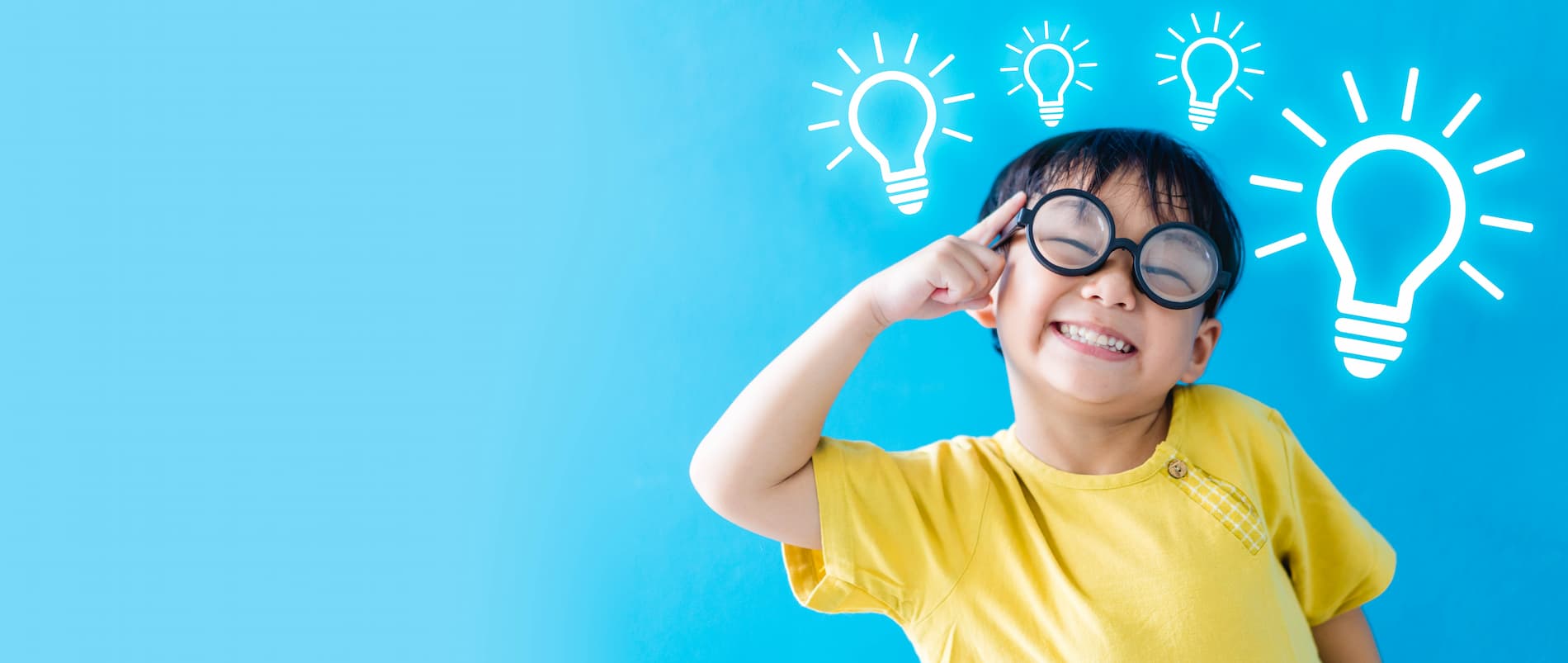 Header image for the Oxis International School - Smiling boy in spectacles